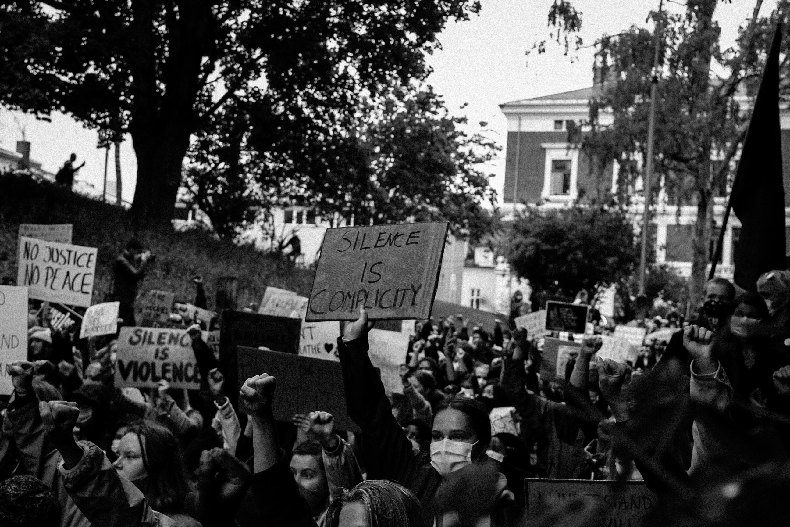 Black and White Photo of People Protesting in Street