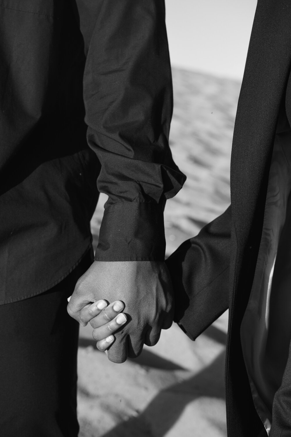 People in Black Clothing Holding Hands